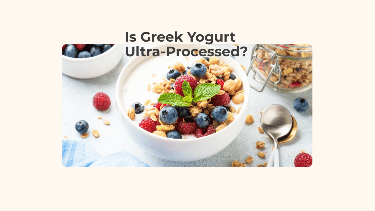 Bowl of Greek yogurt topped with blueberries, raspberries, granola, and mint leaves beside a jar of granola, with the title "Is Greek Yogurt Ultra-Processed?